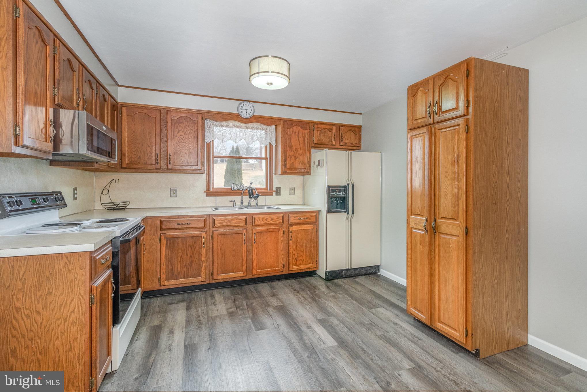 15 Penn Circle Hanover, PA 17331 - Photo 6 of 32 a kitchen with a refrigerator a sink and wooden floors