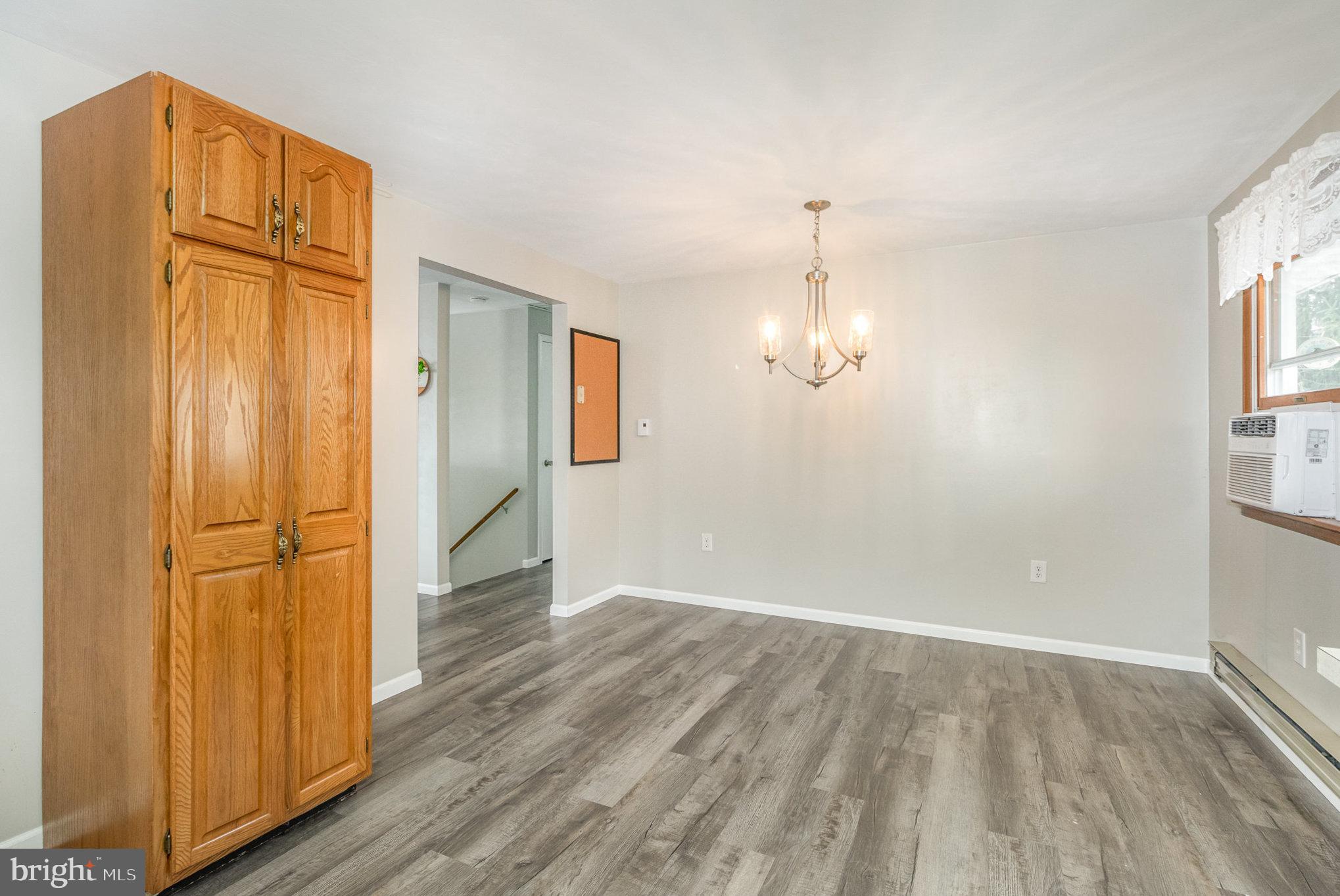 15 Penn Circle Hanover, PA 17331 - Photo 8 of 32 an empty room with wooden floor cabinet and windows