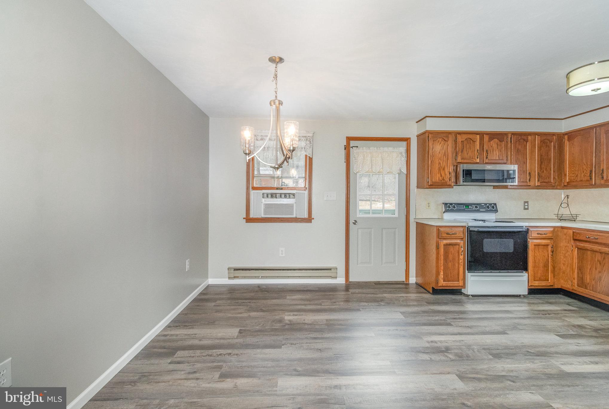 15 Penn Circle Hanover, PA 17331 - Photo 9 of 32 a view of kitchen with stainless steel appliances granite countertop a stove a sink and a refrigerator with wooden floor