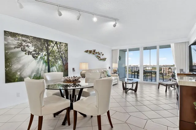 a view of a dining room with furniture large windows and wooden floor
