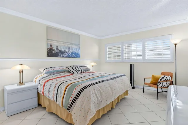 a bedroom with bed and a window