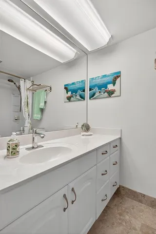 a bathroom with a double vanity sink and mirror
