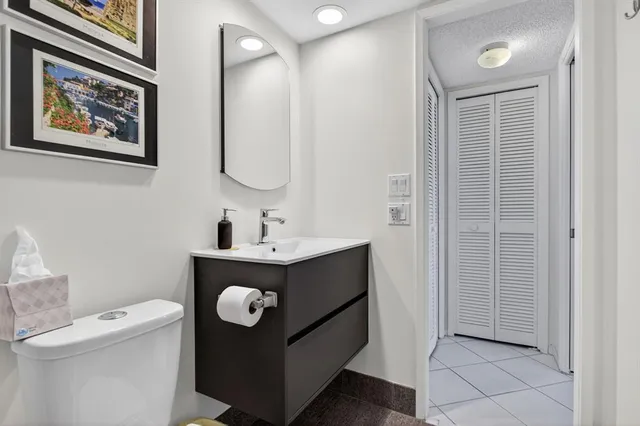 a bathroom with a sink a toilet and mirror