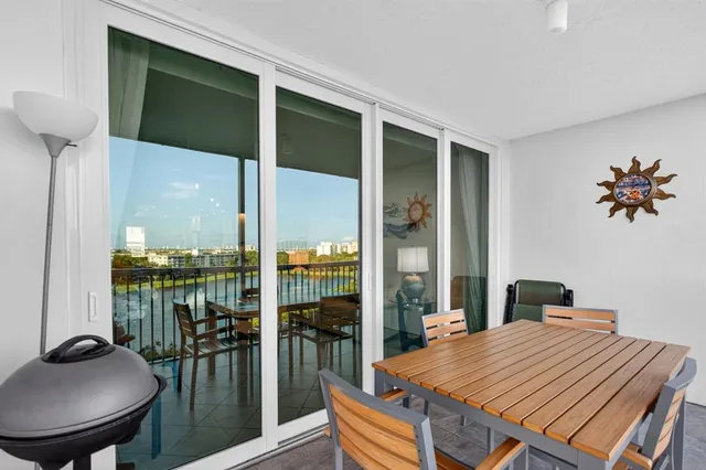 a dining room with furniture and a floor to ceiling window