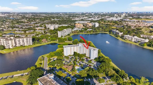 an aerial view of residential houses with outdoor space and river