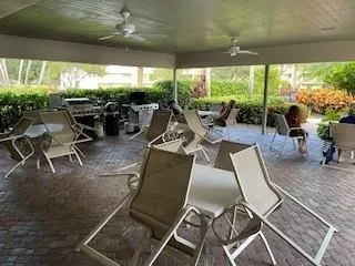 a view of a patio with table and chairs and potted plants