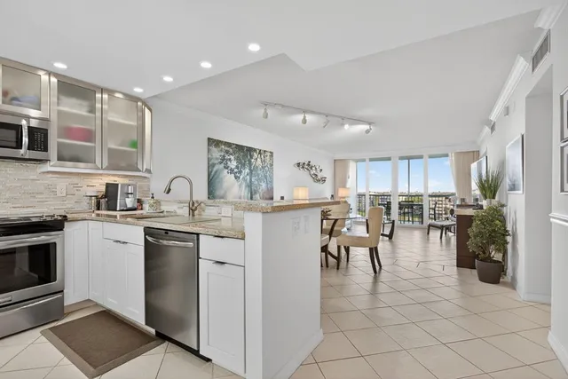 a kitchen with cabinets and chairs