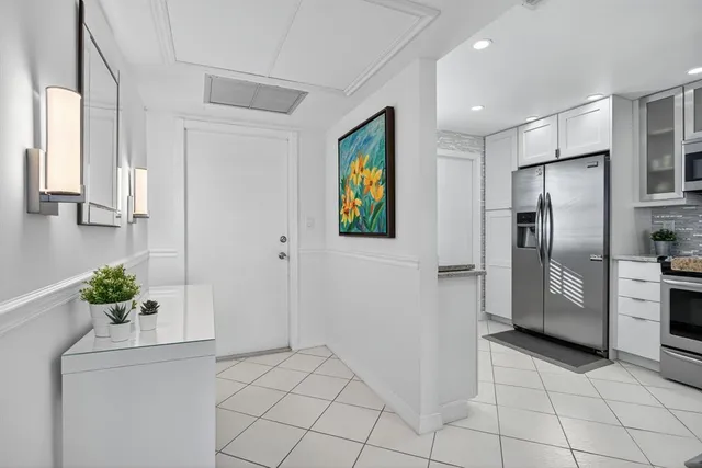 a kitchen with stainless steel appliances a refrigerator and a counter top space