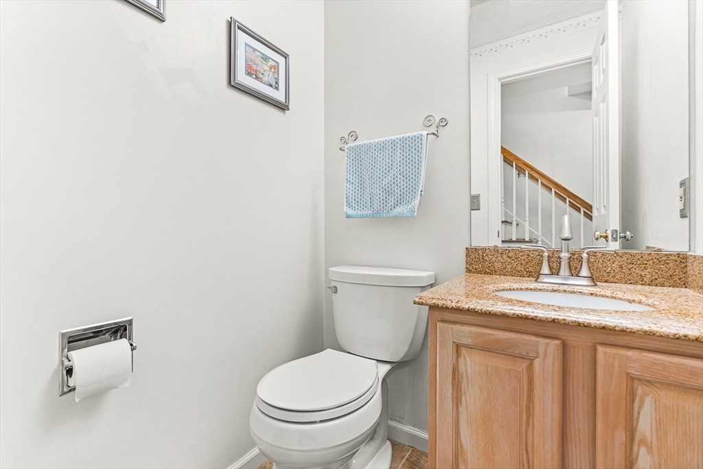 112 Abington Road, Unit 112 Danvers, MA 01923 - Photo 13 of 38 a bathroom with a granite countertop sink mirror vanity and toilet