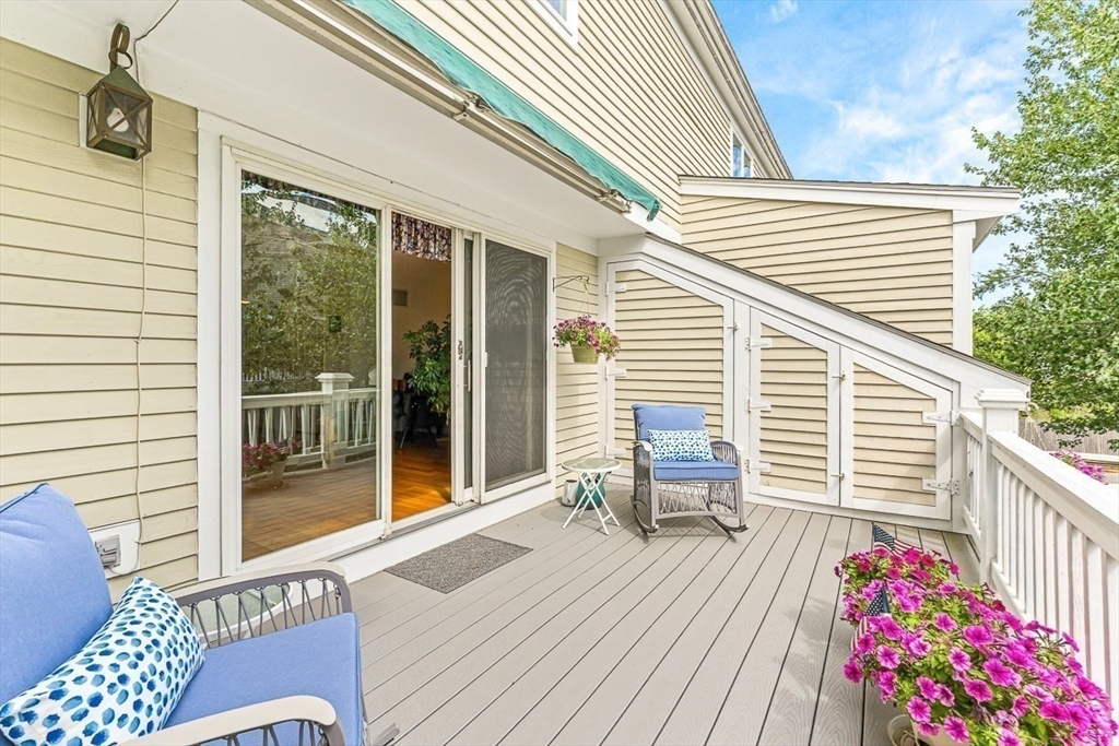 112 Abington Road, Unit 112 Danvers, MA 01923 - Photo 24 of 38 a balcony with wooden floor and furniture
