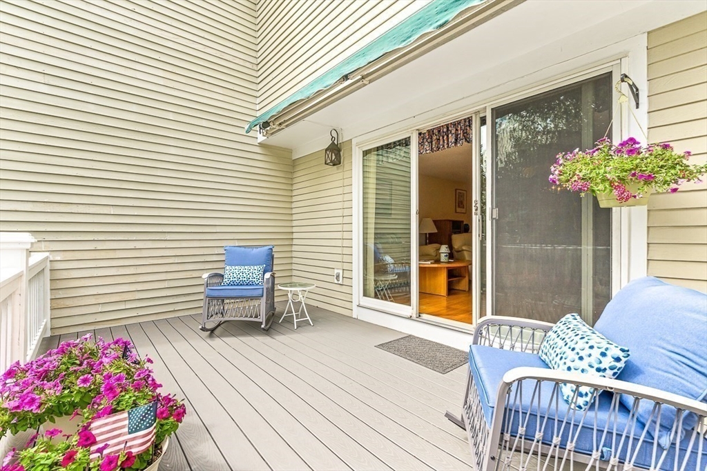 112 Abington Road, Unit 112 Danvers, MA 01923 - Photo 25 of 38 a balcony with furniture and flowers