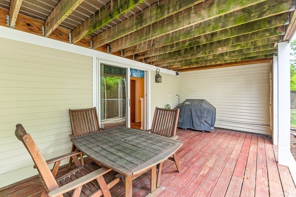 112 Abington Road, Unit 112 Danvers, MA 01923 - Photo 28 of 38 a view of a wooden chairs and table in the balcony