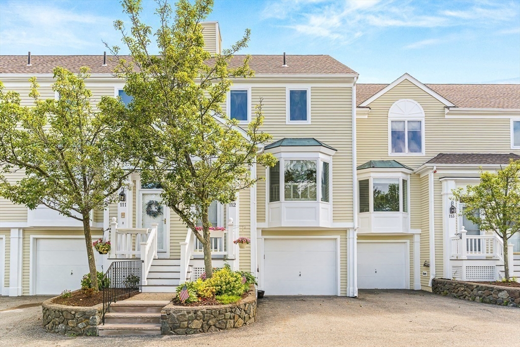 112 Abington Road, Unit 112 Danvers, MA 01923 - Photo 3 of 38 a front view of a house with a garden