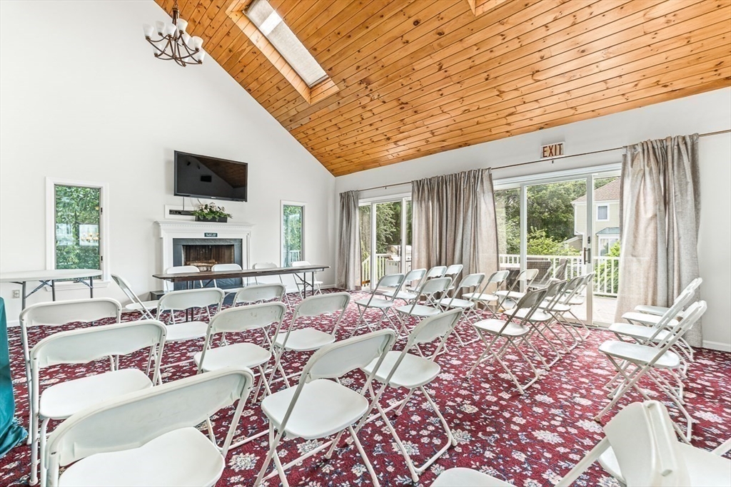 112 Abington Road, Unit 112 Danvers, MA 01923 - Photo 32 of 38 a living room with furniture fireplace and a large window