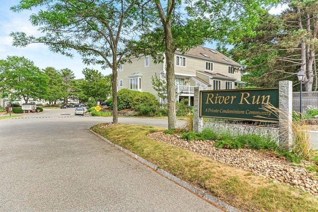 112 Abington Road, Unit 112 Danvers, MA 01923 - Photo 35 of 38 a street sign on a sidewalk next to a road