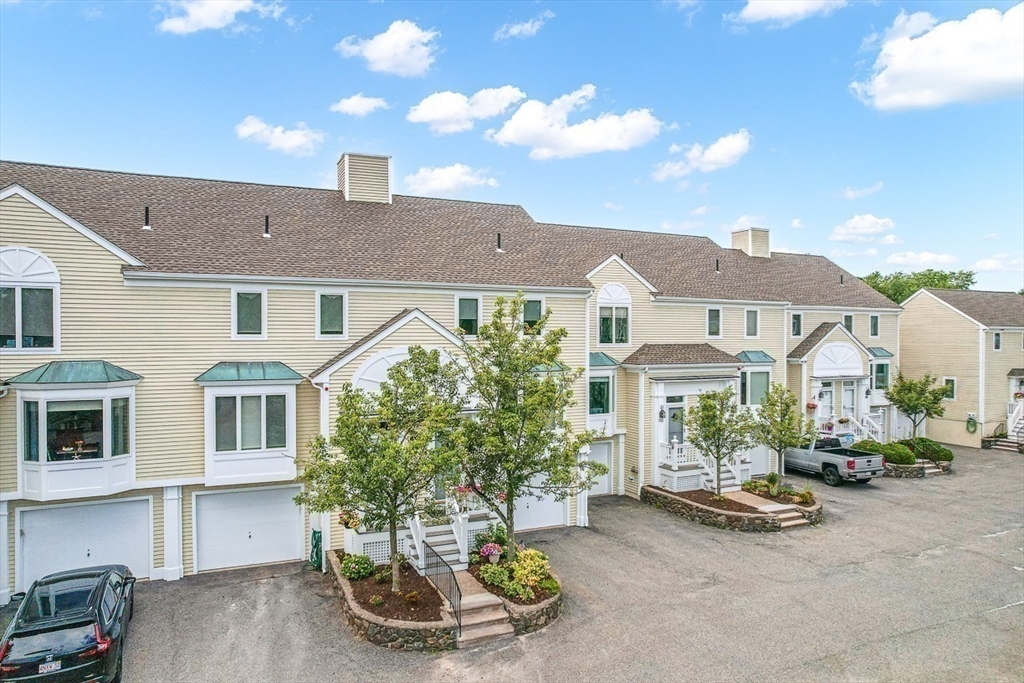 112 Abington Road, Unit 112 Danvers, MA 01923 - Photo 36 of 38 a front view of a house with a garden and patio