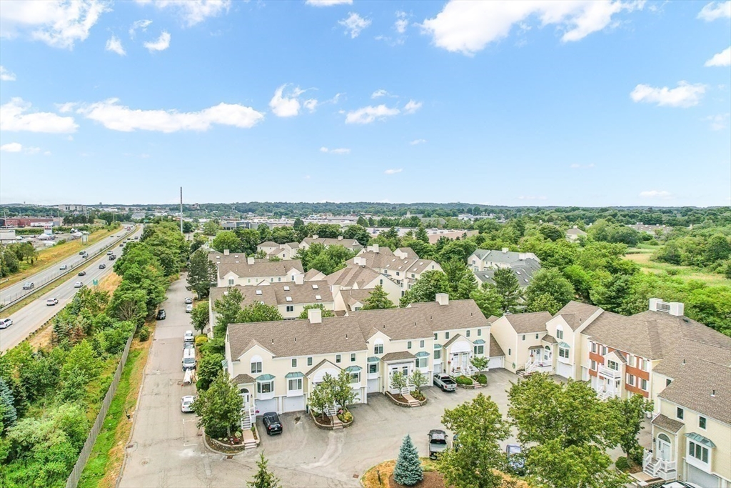 112 Abington Road, Unit 112 Danvers, MA 01923 - Photo 37 of 38 an aerial view of a city with lots of residential buildings ocean and mountain view in back