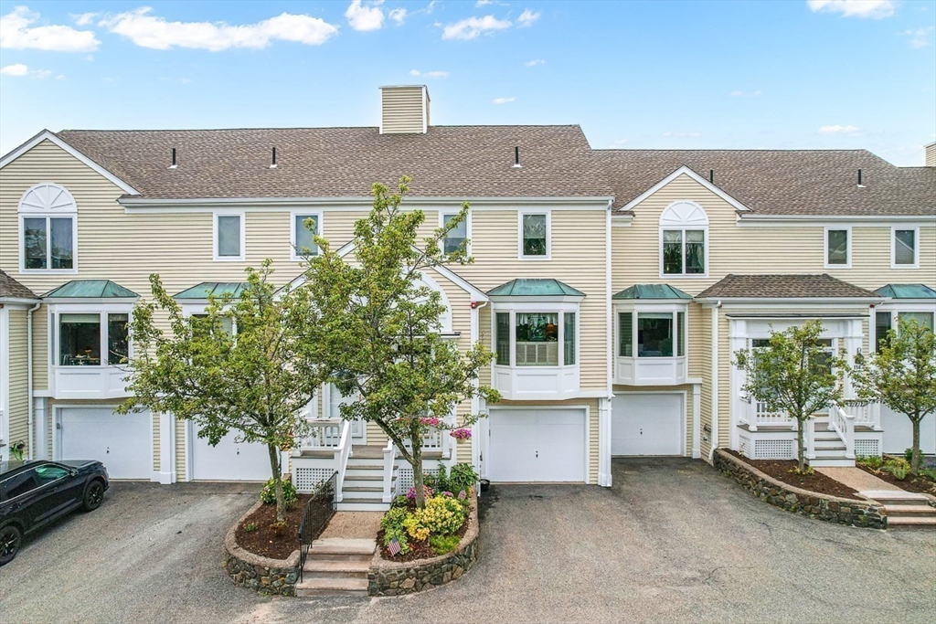 112 Abington Road, Unit 112 Danvers, MA 01923 - Photo 4 of 38 a front view of a house with a yard and garage