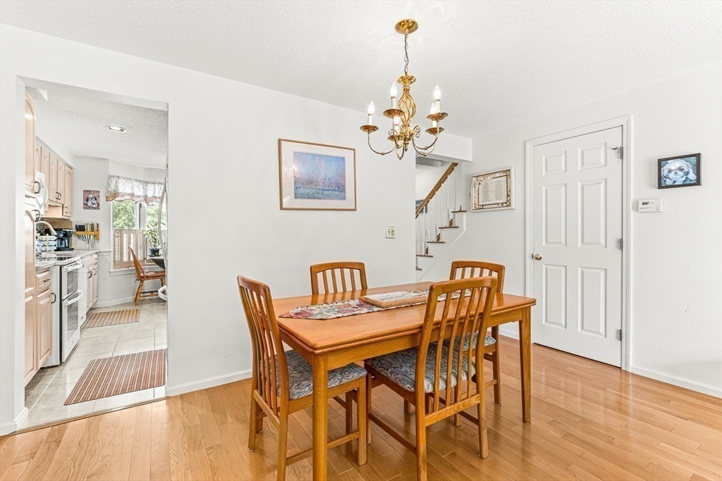 112 Abington Road, Unit 112 Danvers, MA 01923 - Photo 8 of 38 a view of a dining room with furniture and wooden floor