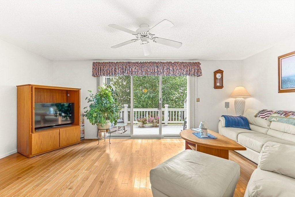112 Abington Road, Unit 112 Danvers, MA 01923 - Photo 9 of 38 a living room with furniture and a large window