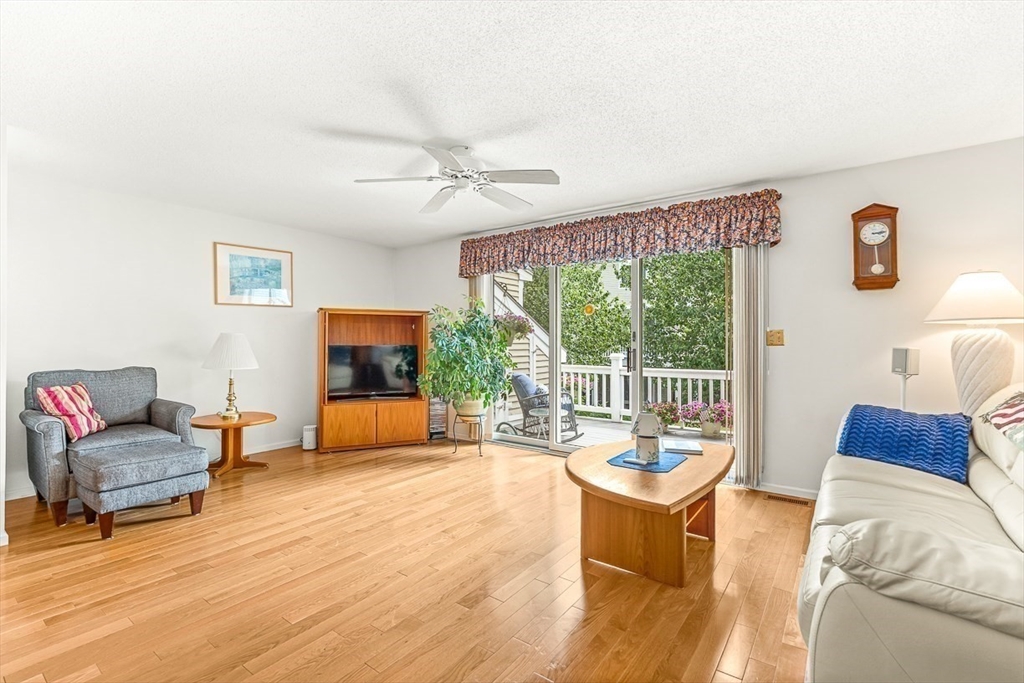 112 Abington Road, Unit 112 Danvers, MA 01923 - Photo 10 of 38 a living room with furniture and a flat screen tv