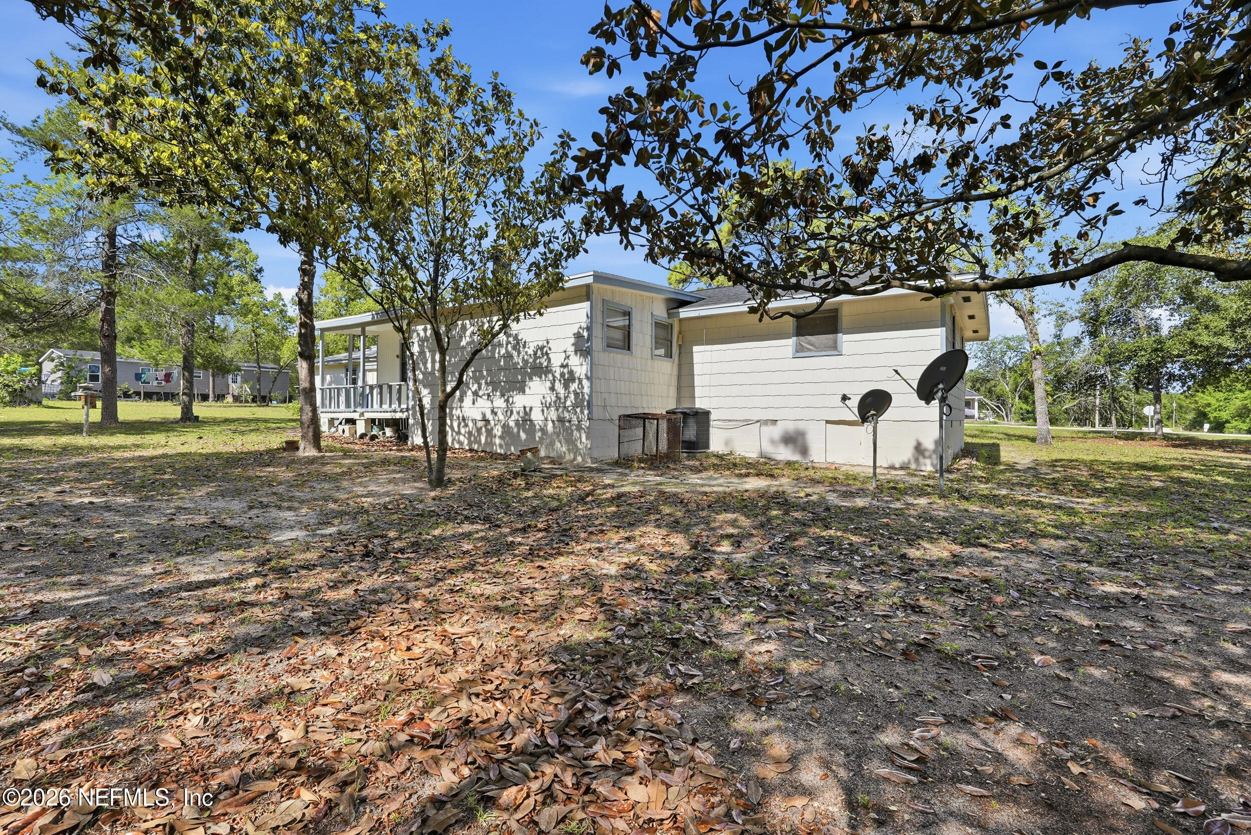 7593 Silver Sands Road Keystone Heights, FL 32656 - Photo 28 of 36 a view of a white house with a yard