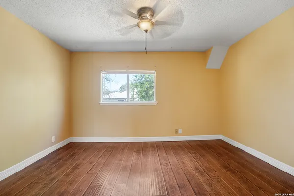 wooden floor in an empty room with a window