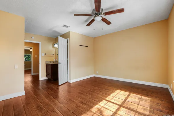 a view of empty room with wooden floor