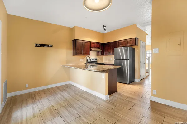 a kitchen with a sink appliances and cabinets