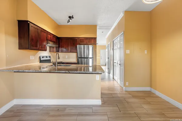 a kitchen with stainless steel appliances granite countertop a sink and cabinets