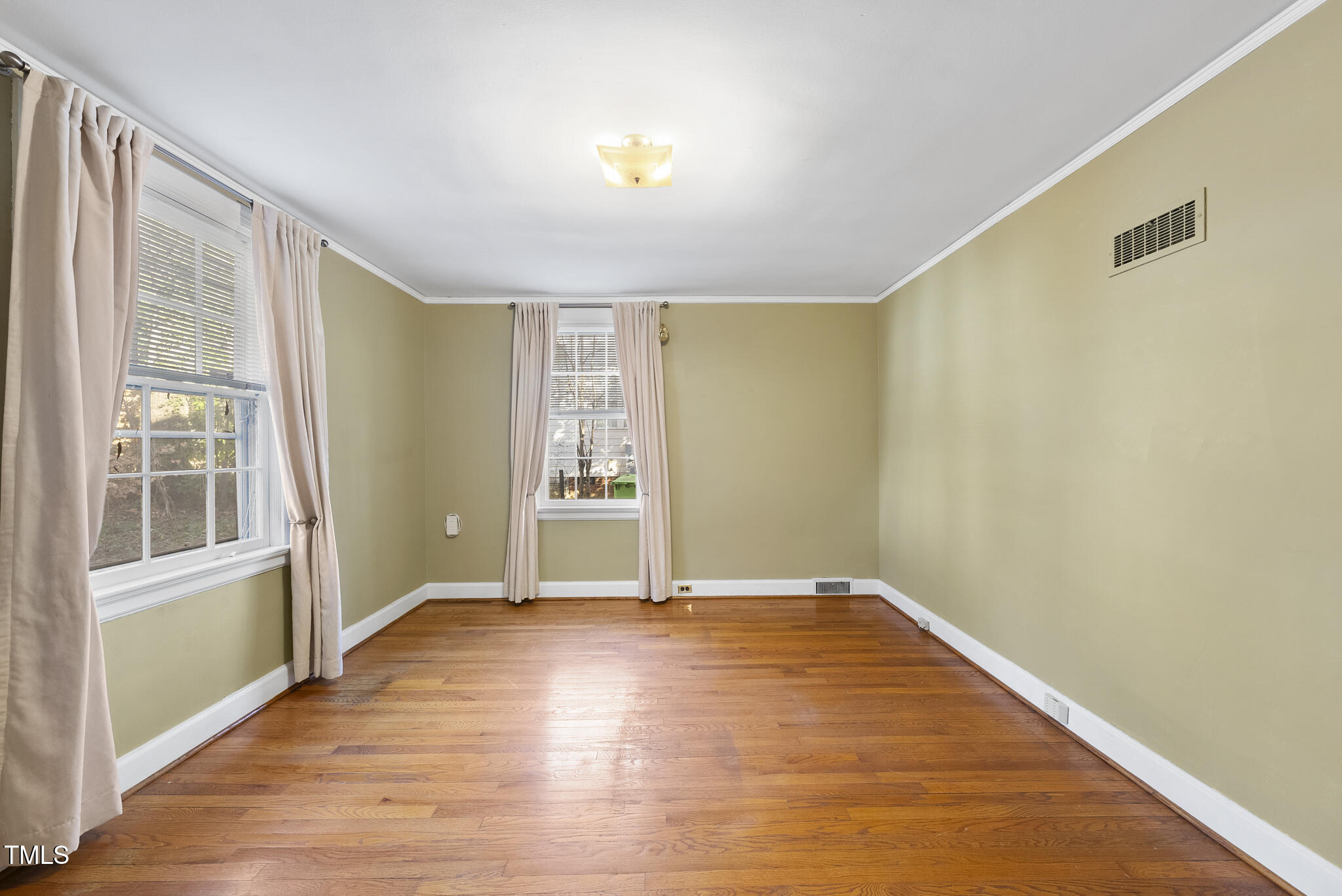 23 Shepherd Street Raleigh, NC 27607 - Photo 12 of 36 a view of an empty room with wooden floor and a window