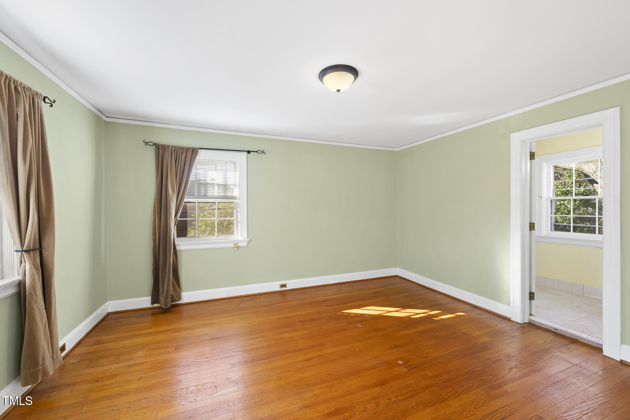 23 Shepherd Street Raleigh, NC 27607 - Photo 21 of 36 an empty room with wooden floor and windows