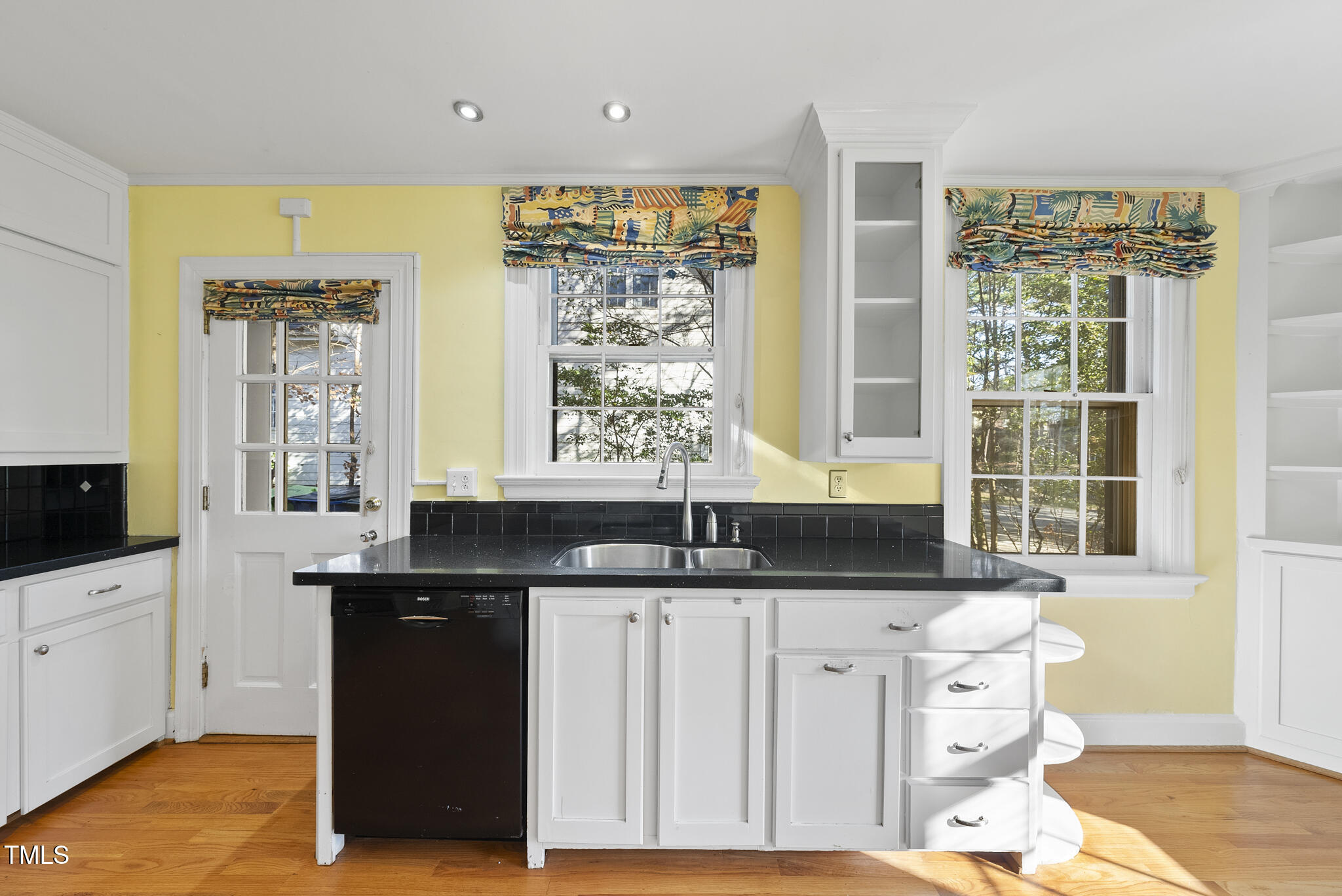 23 Shepherd Street Raleigh, NC 27607 - Photo 5 of 36 a kitchen with granite countertop a sink and white cabinets
