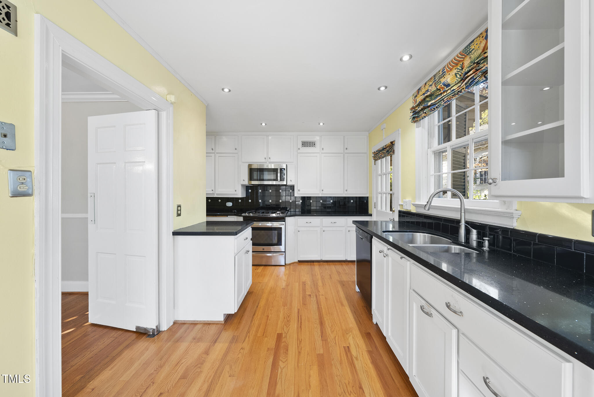 23 Shepherd Street Raleigh, NC 27607 - Photo 6 of 36 a large kitchen with stainless steel appliances granite countertop a lot of counter space and wooden floors