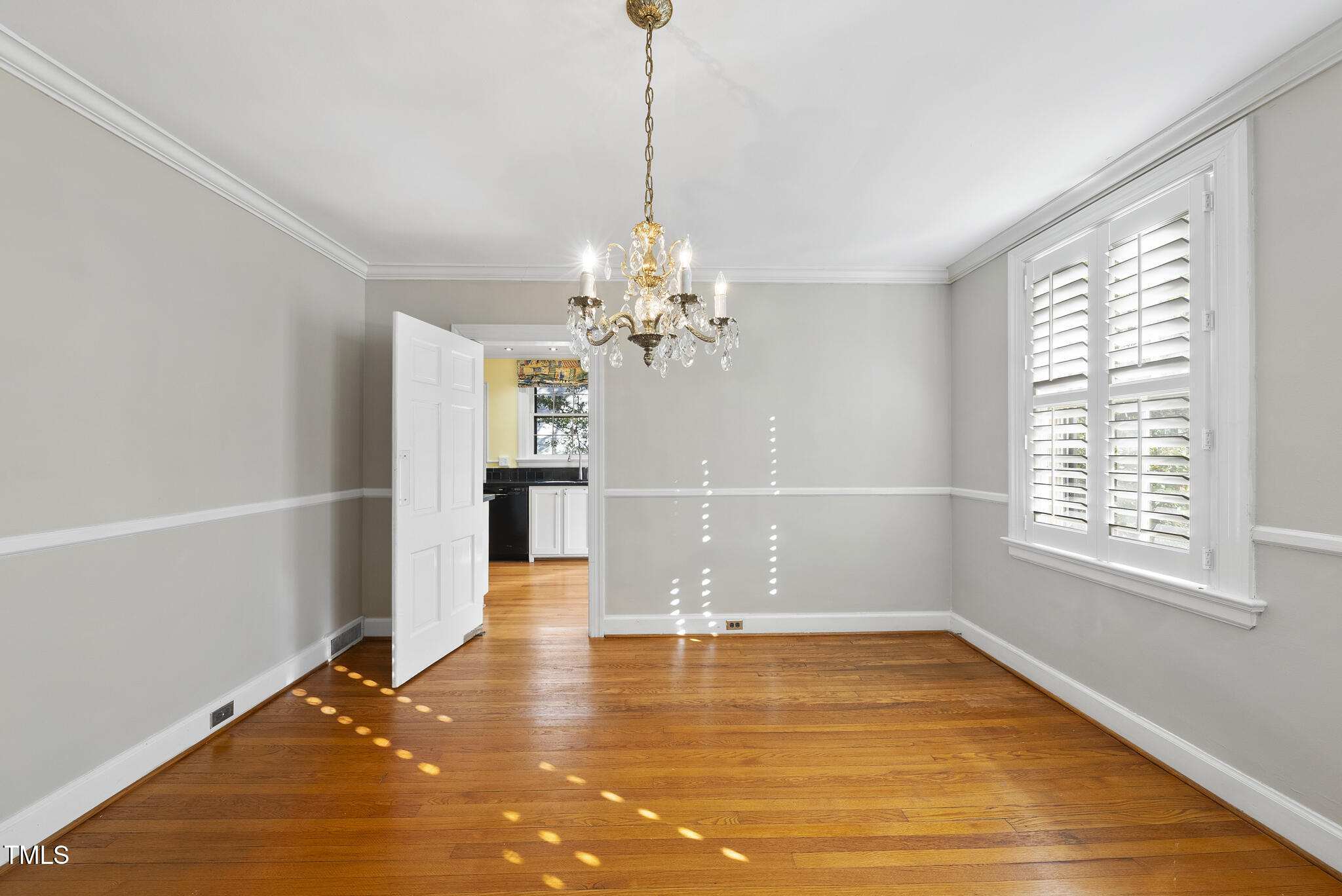 23 Shepherd Street Raleigh, NC 27607 - Photo 9 of 36 a view of a room with wooden floor and chandelier