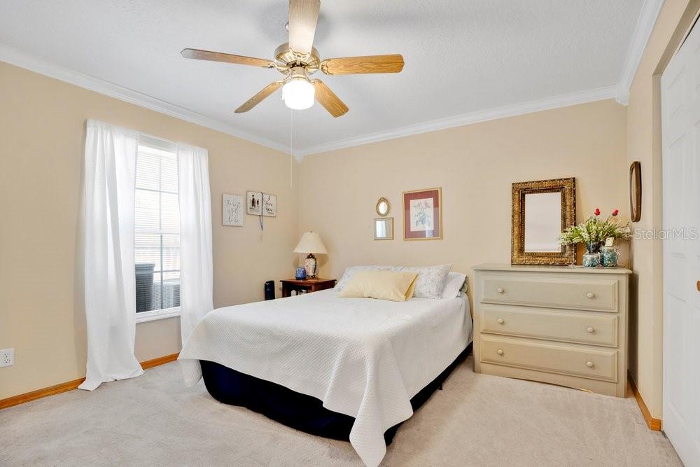 525 Rachael Court Oviedo, FL 32765 - Photo 21 of 37 a bedroom with a large bed and a chandelier