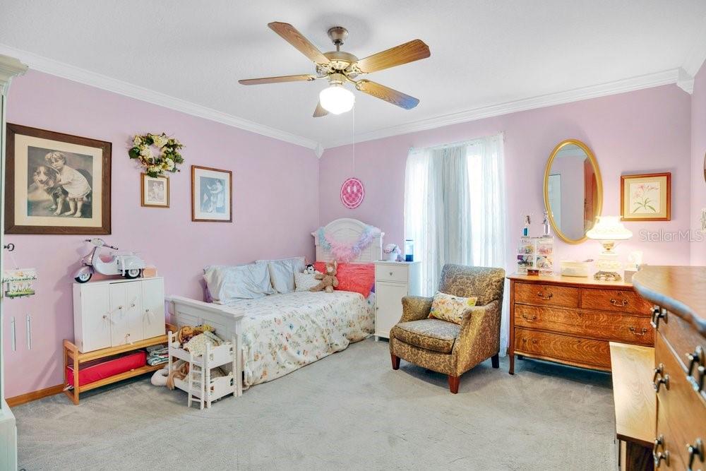 525 Rachael Court Oviedo, FL 32765 - Photo 23 of 37 a bedroom with a bed and a chandelier