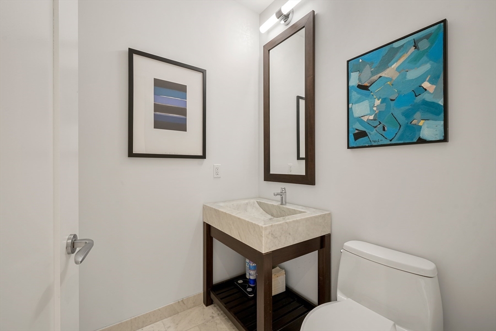 1 Franklin Street, Unit 4802 Boston, MA 02110 - Photo 16 of 42 a bathroom with a toilet a sink and mirror