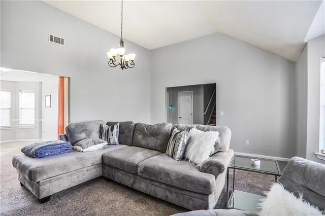 a living room with furniture and a chandelier
