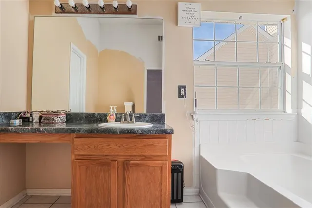 a bathroom with a granite countertop sink and a mirror