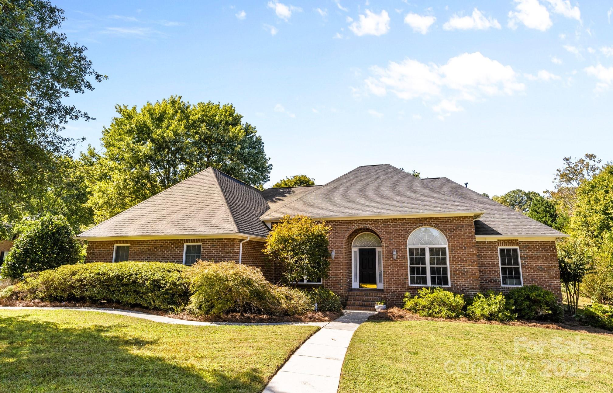 a front view of a house with yard and green space