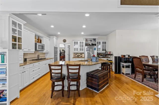 a living room with stainless steel appliances kitchen island granite countertop furniture and a kitchen view