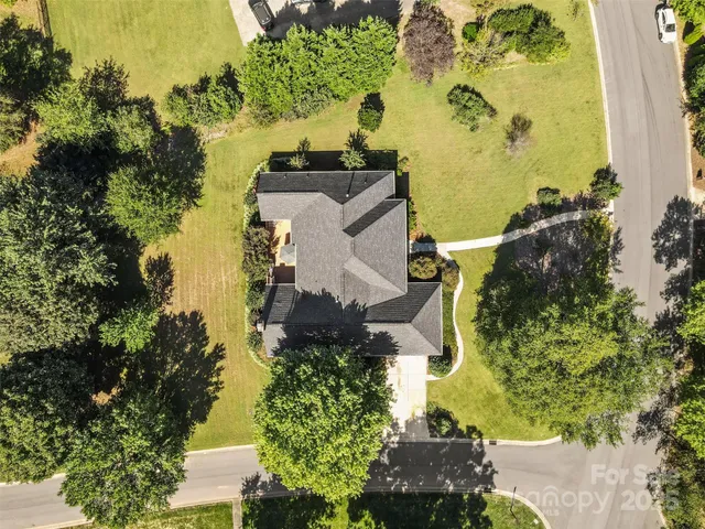 an aerial view of a house with a yard