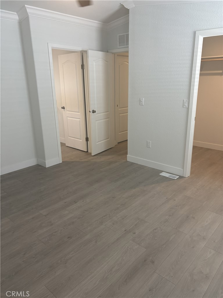 10550 Dunlap Crossing Road, Unit 27 Whittier, CA 90606 - Photo 11 of 14 an empty room with wooden door