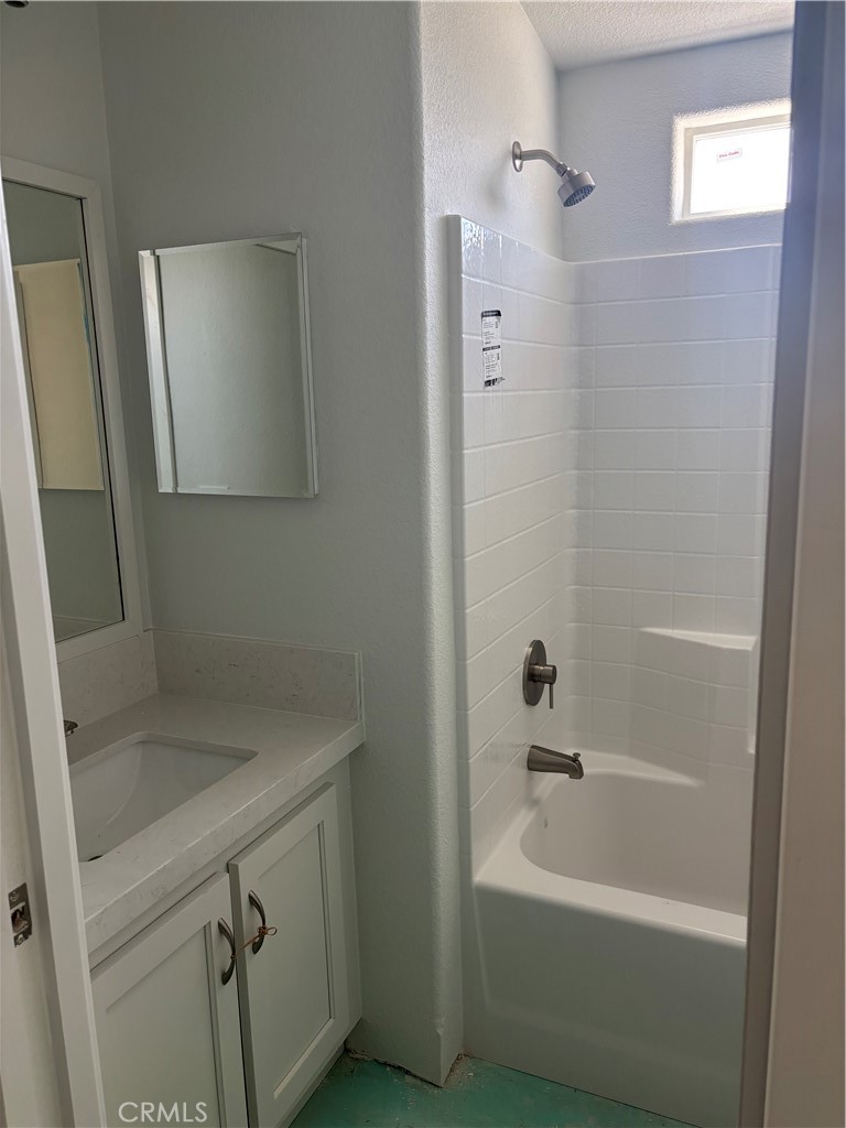 10550 Dunlap Crossing Road, Unit 27 Whittier, CA 90606 - Photo 11 of 13 a bathroom with a sink a mirror and a bathtub