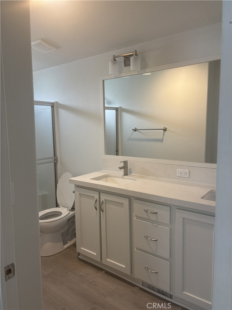 10550 Dunlap Crossing Road, Unit 27 Whittier, CA 90606 - Photo 12 of 14 a bathroom with a double vanity sink and a mirror