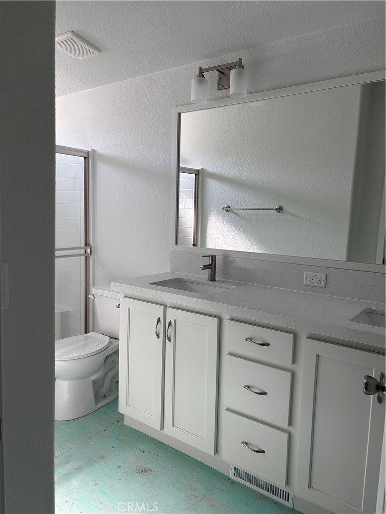 10550 Dunlap Crossing Road, Unit 27 Whittier, CA 90606 - Photo 12 of 13 a bathroom with a granite countertop toilet sink and mirror