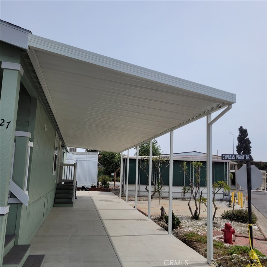 10550 Dunlap Crossing Road, Unit 27 Whittier, CA 90606 - Photo 2 of 13 a view of a patio with a table and chairs under an umbrella