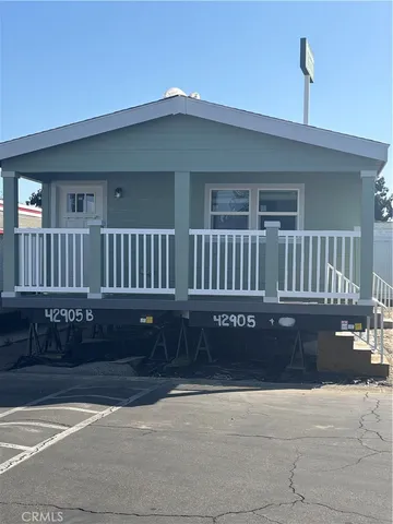a view of a house with a wooden fence