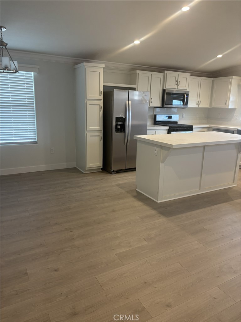 10550 Dunlap Crossing Road, Unit 27 Whittier, CA 90606 - Photo 4 of 14 a kitchen with stainless steel appliances granite countertop a refrigerator sink and cabinets